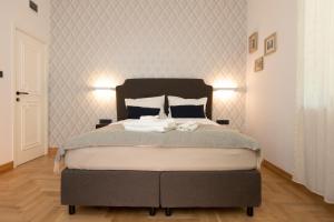 a bedroom with a large bed with two towels on it at Luxury rooms 12-1 in Plovdiv