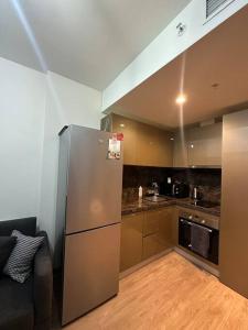 eine Küche mit einem Kühlschrank aus Edelstahl in einem Zimmer in der Unterkunft Merkezi, havuzlu, lüx site içerisinde komförlü homeoffice in Istanbul