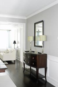 a living room with a dresser and a mirror at Zenith residence in Ulsan