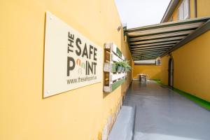 a building with a sign on the side of it at The Safe Point Residential Castillo in Castillo del Romeral