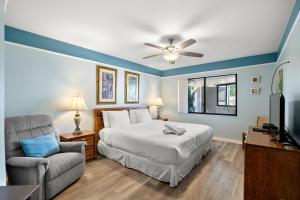 a bedroom with a bed and a couch and a television at Bayview Condo B in Bradenton Beach +38 photos