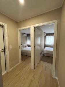 a room with two beds and a hallway with a bedroom at Oporto Near Family Apartments in Porto
