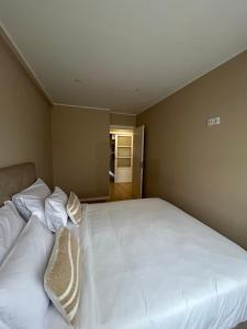 a bedroom with a large white bed with pillows at Oporto Near Family Apartments in Porto