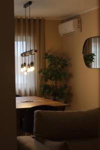 a dining room with a table with plants on it at Oporto Near Family Apartments in Porto