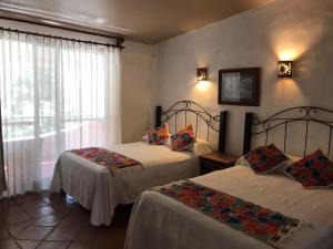 Ένα ή περισσότερα κρεβάτια σε δωμάτιο στο Posada Los Colorines