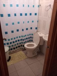 a bathroom with a toilet and a sink at cabañas de la casona in Punta de Choros