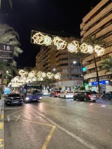 a bus driving down a city street with christmas lights at Habitación Sol Connect in Alicante