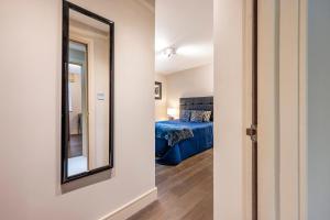 a hallway with a mirror and a bed in a room at CAMDEN Lux Apartment-Hosted by Sweetstay in London