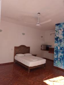 um quarto com uma cama e um tecto em Blue Hotel em Bacalar