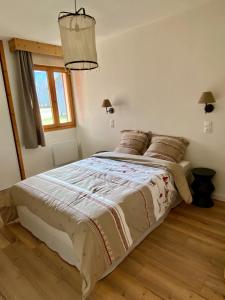 een slaapkamer met een groot bed in een kamer bij Appartement rénové T2, vue montagne in Samoëns