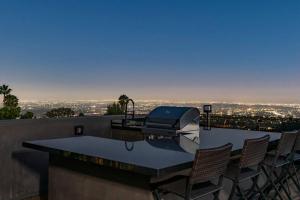 a room with a table and chairs on a roof at Luxurious Modern Mansion Hollywood Hills in Los Angeles