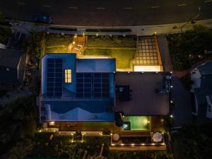 an aerial view of a house at night with lights at Luxurious Modern Mansion Hollywood Hills in Los Angeles