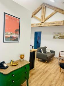 a living room with a green cabinet and a couch at La Belle Etape à Carcassonne in Carcassonne