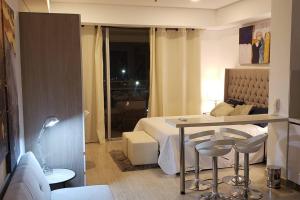 1 dormitorio con 1 cama, mesa y sillas en New Beach loft in Cartagena close to the airport, en Cartagena de Indias