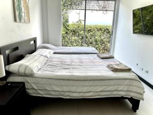 Säng eller sängar i ett rum på Condo Tranquilo, Cómodo y Moderno en Santa Ana