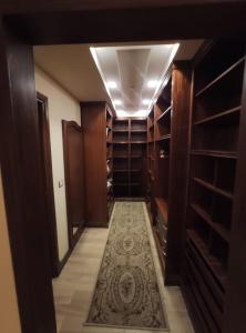 a walk in closet with wooden shelves and a rug at برج سما الحرية in Alexandria