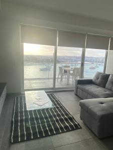 a living room with a couch and a table at Sliema Seaview & seafront- APT 9, 49 Tigne Point Mansions in Sliema