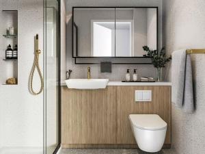 a bathroom with a sink and a toilet and a mirror at Brand New 1 Bed Modern Apartment in London