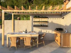 a table and chairs sitting under a pergola at Apartment Ela with private jacuzzi in Podgora