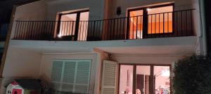 a balcony of a house with a door and windows at Can Romaní - Casa compartida con propietario - Baño compartido in L'Escala