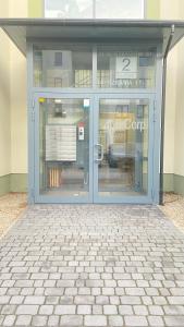 an entrance to a building with glass doors at Apartament Złocień in Krakow