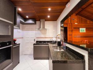 a kitchen with a sink and a counter top at Angra Pier600 Casa beira mar in Angra dos Reis