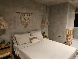 a bedroom with a large white bed in it at Como River Retreat in Cavinti