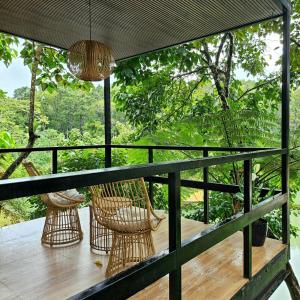 a balcony with hammocks and a view of the forest at Como River Retreat in Cavinti