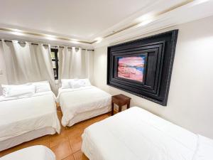 Posteľ alebo postele v izbe v ubytovaní Hotel Villa Antigua