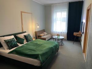 a hotel room with a bed and a couch at Apartamenty na Starówce - Apartments in the Old Town in Cieszyn