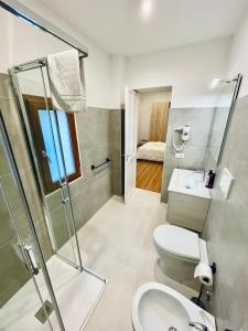 a bathroom with a shower and a toilet and a sink at Suite San Biagio in Lecce
