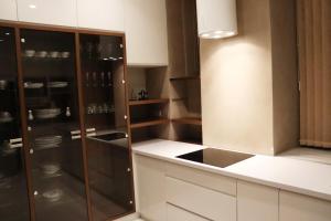 a kitchen with brown and white cabinets and a sink at Capital apartments Sarajevo in Sarajevo