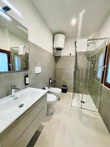 a bathroom with a toilet and a sink and a shower at Suite San Biagio in Lecce