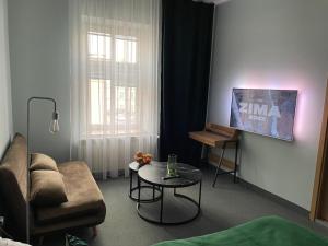 a living room with a couch and a table at Apartamenty na Starówce - Apartments in the Old Town in Cieszyn