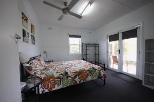 a bedroom with a bed and a ceiling fan at Bonnydoon at Hat Head (Pet Friendly) in Hat Head