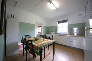 a kitchen and dining room with a table and chairs at Bonnydoon at Hat Head (Pet Friendly) in Hat Head