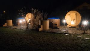 a row of wooden cabins at night with lights at Górskie Wytchnienie in Jelenia Góra