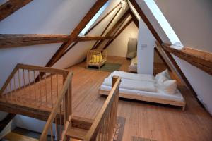 an attic room with a bed and a staircase at Ferienwohnung "Zur Krone" - zentrale Lage - NEU - in Zell im Wiesental