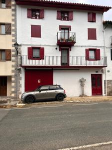 a silver car parked in front of a building at Magdalenea - Apartamento in Lesaka