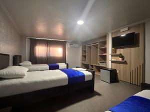 Postel nebo postele na pokoji v ubytování Hotel Cataleya Al-Hoceima