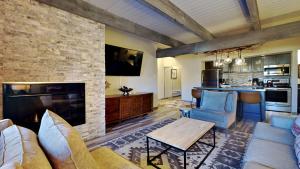 a living room with a brick wall and a fireplace at Timberline Condominiums 1 Bedroom Premier Unit D2B in Snowmass Village