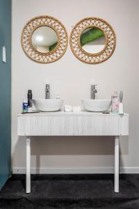 a bathroom with two sinks and two mirrors at NAP v in Valencia