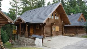 a log cabin with a black roof at Drevenica Donovaly in Donovaly