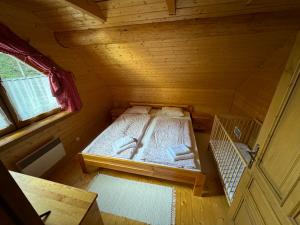 an overhead view of a bed in a wooden room at Drevenica Donovaly in Donovaly