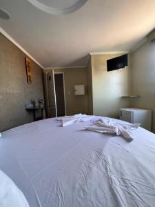 Postel nebo postele na pokoji v ubytování Hotel Paradise