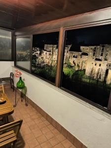 a room with two windows with a view of a city at BELLEVUE APARTMENTS in Sant'Agata de' Goti