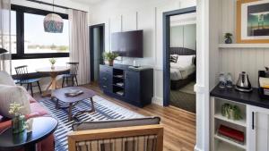 a living room with a couch and a bed in a room at El Capitan Hotel in Merced