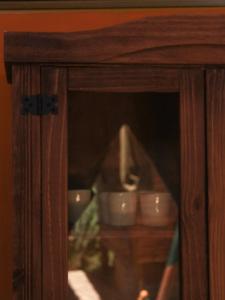 a wooden cabinet with two dishes in it at Valhalla Glamping House in Bombinhas +124 photos