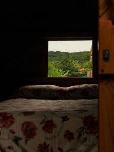 a bedroom with a bed and a window with a view at Valhalla Glamping House in Bombinhas