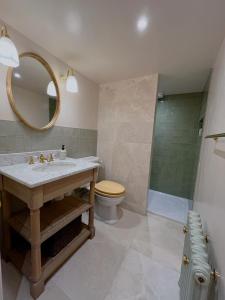 a bathroom with a sink and a toilet and a mirror at Forge Cottage Suffolk in Sudbury